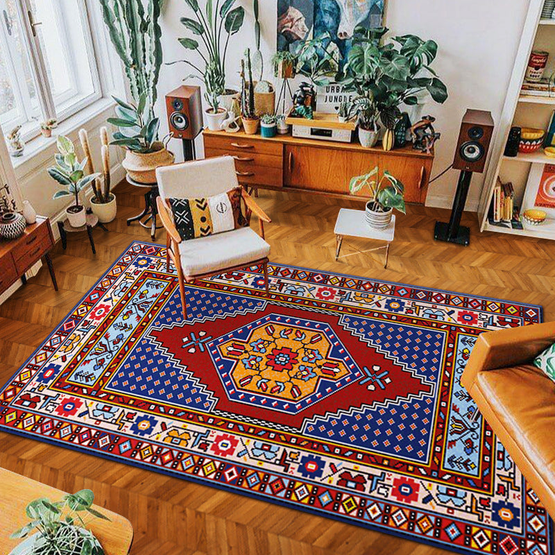 Colorful tribal-inspired woven rug on wooden floor