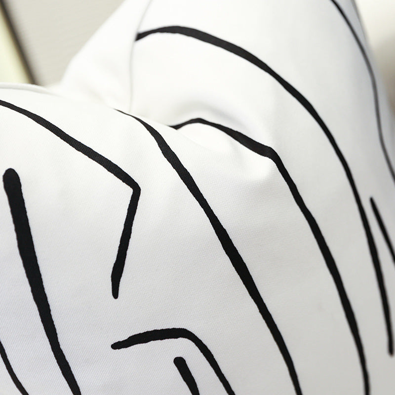 Single white geometric cushion cover with abstract black pattern