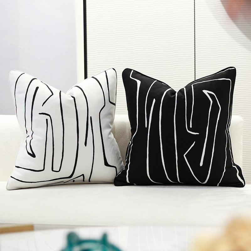 Black and white geometric cushion covers on a sofa in modern living room