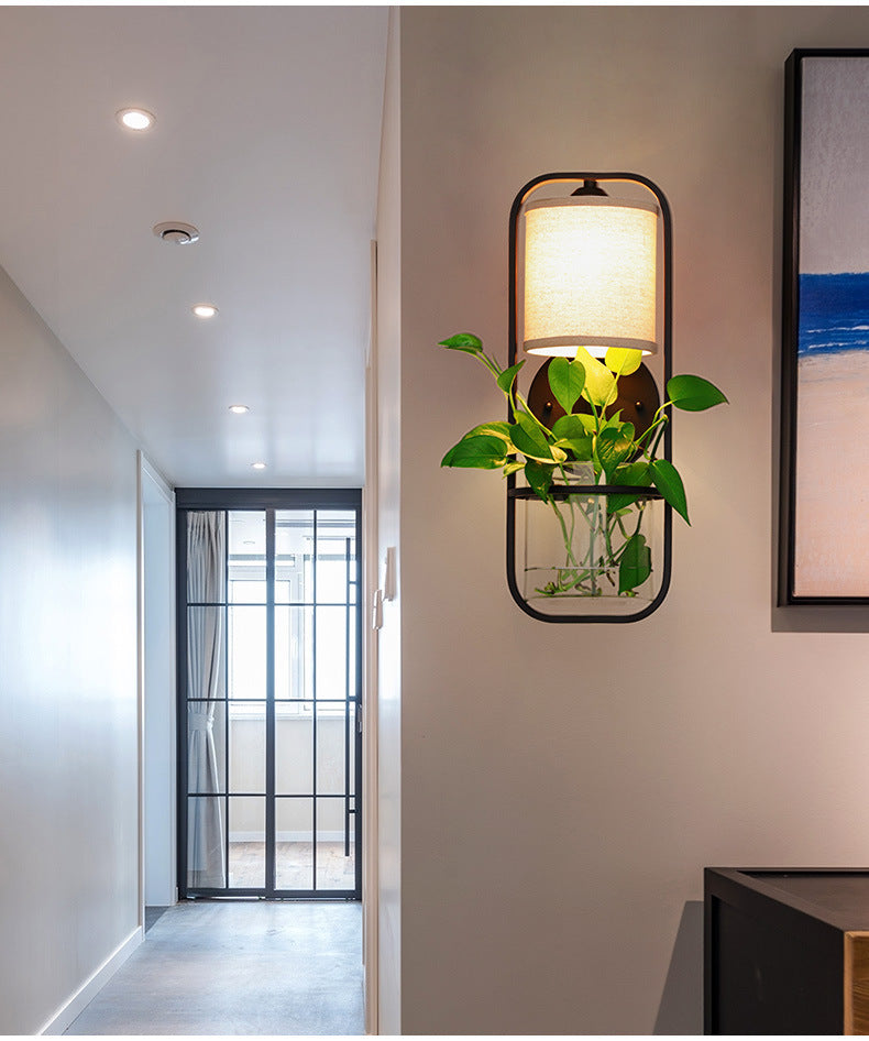 Black frame floor lamp with indoor plants and warm lighting