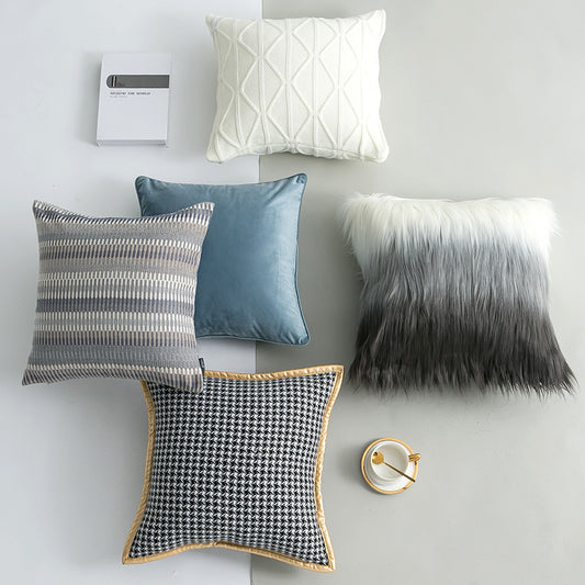 Collection of decorative pillows on a plain background