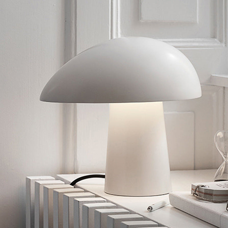 Minimalist mushroom lamp with wooden stand on a shelf