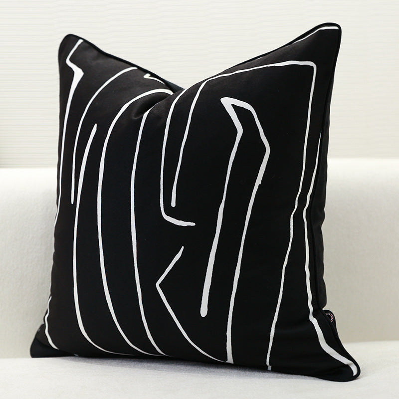 Single black geometric cushion cover with abstract white pattern