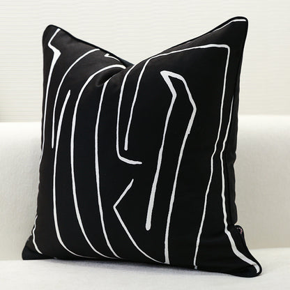 Single black geometric cushion cover with abstract white pattern