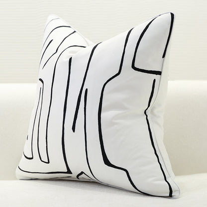 Single white geometric cushion cover with abstract black pattern