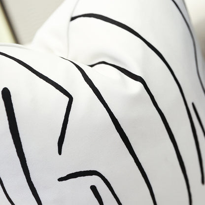 Single white geometric cushion cover with abstract black pattern
