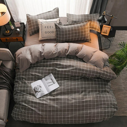 Bed with gray checkered bedding and decorative pillows in a bedroom setting.